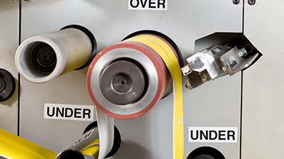 Etichette indicanti la direzione della produzione di un macchinario roll-to-roll.