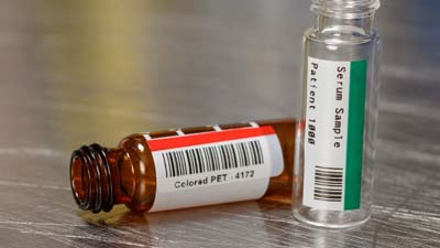 Due fiale con etichetta in poliestere rossa e verde.